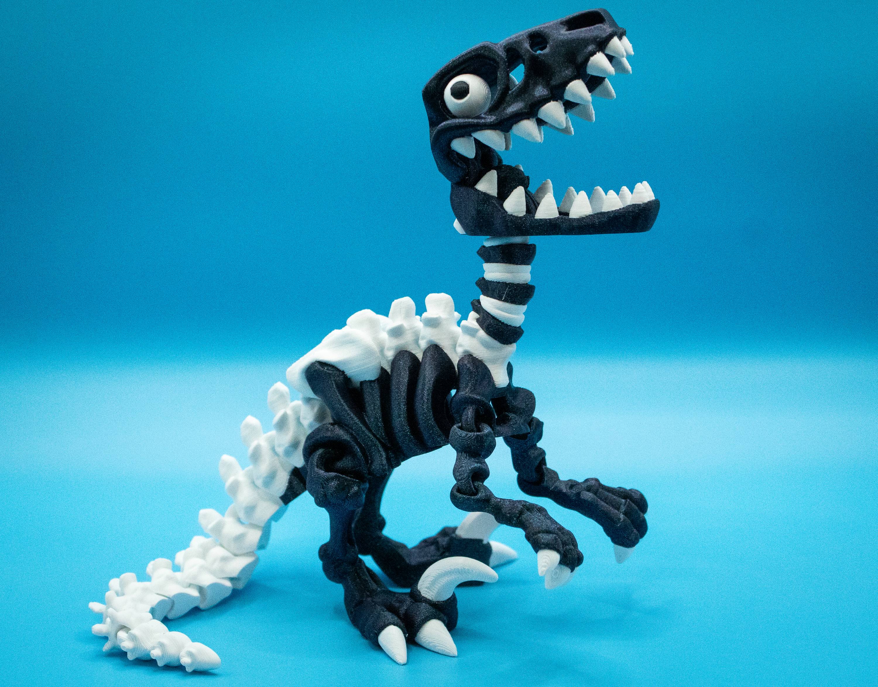 3D Printed Velociraptor toy figure on a blue background for imaginative play in a fantasy collection