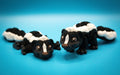 Articulated 3D printed skunk toy posed on a blue background, showcasing its detailed design and flexible joints.